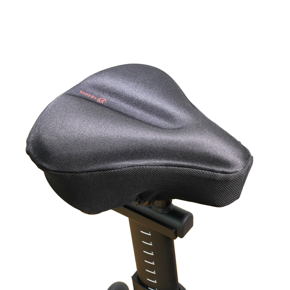 Front angled view of the YESOUL bike seat cover wide edition installed on an indoor exercise bike, showing the black padded saddle and seat structure.